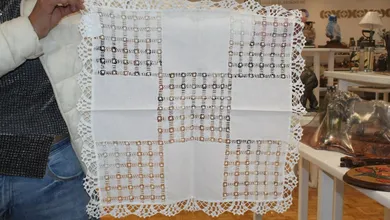El deshilado consiste en retirar hilos de una tela de manera precisa para crear calados decorativos, que posteriormente se rellenan con bordados hechos a mano.